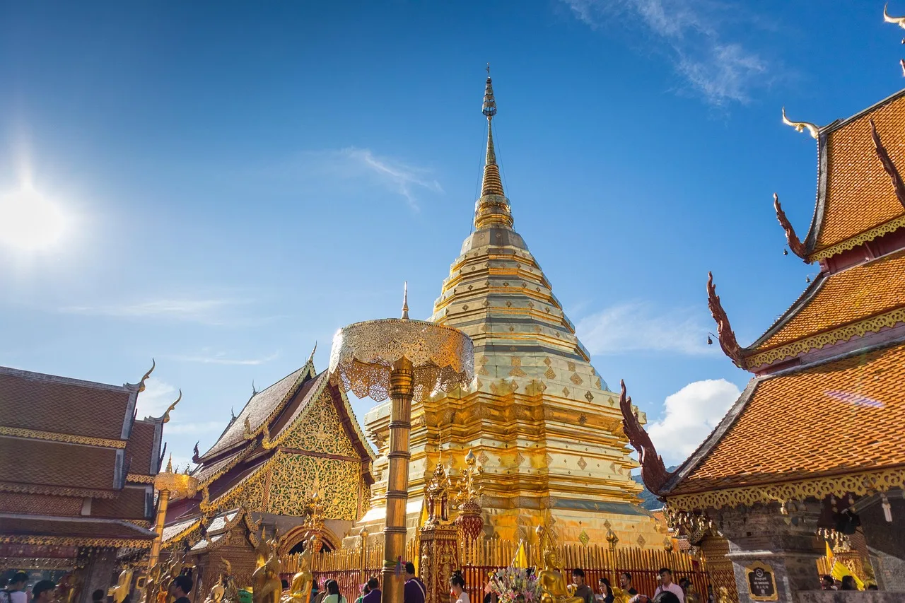 The golden chedi of Wat Phra That Doi Suthep temple above Chiang Mai under a clear blue sky